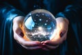 Close-up of a mystical glowing crystal ball being held in the hands of a mysterious woman telling the future Royalty Free Stock Photo