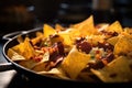 close-up of nacho chips and cheese in a skillet