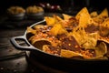 close-up of nacho chips and cheese in a skillet