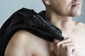 Close up of naked man with his clothes slinging on his shoulder Royalty Free Stock Photo