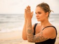 Close up namaste mudra. Attractive Caucasian woman practicing yoga and meditation on the beach. Hands in namaste. Yoga concept. Royalty Free Stock Photo