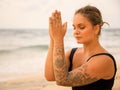 Close up namaste mudra. Attractive Caucasian woman practicing yoga and meditation on the beach. Hands in namaste. Closed eyes. Royalty Free Stock Photo