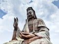 The Nanhai guanyin sitting statue on the back of the white clouds Royalty Free Stock Photo