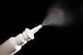 Close-up of nasal drug spraying on black