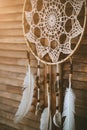 Close up of Native american indian magical dreamcatcher with sacred feathers. amulet on wooden background. Shaman Royalty Free Stock Photo