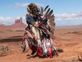 Close Up of a Native American Man Wearing Spotted Feather Headdress and Eagle Feather Bustle in Monument Valley Royalty Free Stock Photo