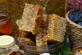 Close up of natural honey comb cut in pieces and honeysuckle berry outside. Royalty Free Stock Photo