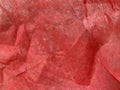 Close-up of natural red fabric or cloth in light red color. Fabric texture of natural cotton or linen textile material. Red canvas Royalty Free Stock Photo