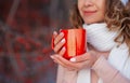 Woman holding winter cup close up on red background.