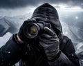 Close-up of nature photographer taking pictures with professional camera in a snowy high mountain landscape. Travel, Nature and Royalty Free Stock Photo