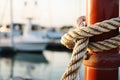 close-up of nautical ropes tied on a bollard at the marina