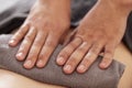 Close-up of neat male masseur hands lying on a towel. A massage therapist does a back massage in a spa salon or clinic Royalty Free Stock Photo
