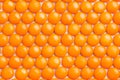 Close up neatly arranged orange milk chocolate candies crisp she Royalty Free Stock Photo