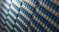 Close-up of neatly arranged rows of blue and tan electronic components, suggesting data transfer or connectivity in technology Royalty Free Stock Photo