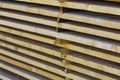 Close-up of neatly piled stack of natural brown rough wooden boa