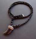 Close up of a necklace made of black crystals on a black surface Royalty Free Stock Photo
