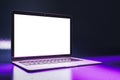 Close up of neon purple light gaming laptop with empty white mock up screen.