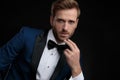 Close up of a nervous groom wearing a blue tuxedo