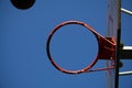 Close up on a netball hoop with net against grey sky