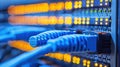 Fiber Optic Cables Connected to a Network Switch with Glowing Lights in Server Room Royalty Free Stock Photo