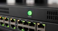 Close-up of a network switch with a glowing green power button and active Ethernet link lights. Royalty Free Stock Photo