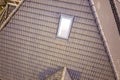 Close-up of new attic plastic window installed in shingled house roof. Professionally done building and construction work, roofing Royalty Free Stock Photo