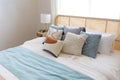 New bed comfort with decorative pillows ,headboard and side table lamp. Royalty Free Stock Photo