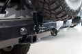 Close-up on a new black tow hitch installed on a offroad car with an iron black bumper in a vehicle repair shop. The device for Royalty Free Stock Photo