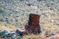 Close up new brown leather shoe on mountain lake view point. Adventure concept, hiker, travel. Copy space Royalty Free Stock Photo