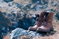Close up new brown leather shoe on mountain lake view point. Adventure concept, hiker, travel. Copy space Royalty Free Stock Photo