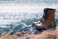 Close up new brown leather shoe on mountain lake view point. Adventure concept, hiker, travel. Copy space Royalty Free Stock Photo