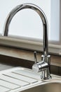 Close-up new chrome tap or faucet in the kitchen. Royalty Free Stock Photo