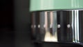 Close up of new coffee machine details. Household utensils. New polished coffee machine of mint color with silver steel