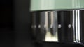 Close up of new coffee machine details. Household utensils. New polished coffee machine of mint color with silver steel