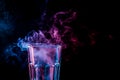 A glass with colorful smoke