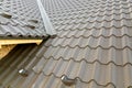 Close up of new house roof structure covered with metal tile sheets Royalty Free Stock Photo