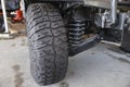 Close-up new military jeep tire and car suspension of an vintage jeep