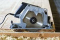 Close-up of new modern powerful circular electrical saw cutting