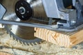 Close-up of new modern powerful circular electrical saw cutting