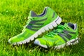 Close up new pairs of green running shoes / sneaker shoes on green grass field in the park