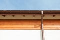 Close up on New Rain Gutter, Downspout, Soffit Board, Fascia Board Installation Against Blue Sky.