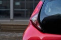 Close up of new red hatchback car parking on local road Royalty Free Stock Photo