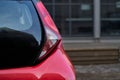 Close up of new red hatchback car parking on local road Royalty Free Stock Photo
