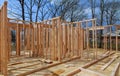 Close-up new stick built home under construction under blue sky Framing structure wood frame of wooden houses home. Royalty Free Stock Photo