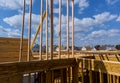 Close-up new stick built home under construction under blue sky Framing structure wood frame of wooden houses home. Royalty Free Stock Photo