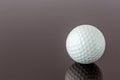 Close up the new white golf ball with the reflection, sport concept. Royalty Free Stock Photo