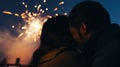 Close-up of a New Year's kiss, blurred background of fireworks in the sky. Silhouette of a loving couple.