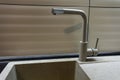 Close up new yellow metal faucet in a kitchen Royalty Free Stock Photo