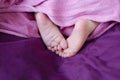 Close-up of newborn babie`s feets, pink rough feets Royalty Free Stock Photo