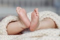 Close up of newborn baby feet covered with the blanket Royalty Free Stock Photo